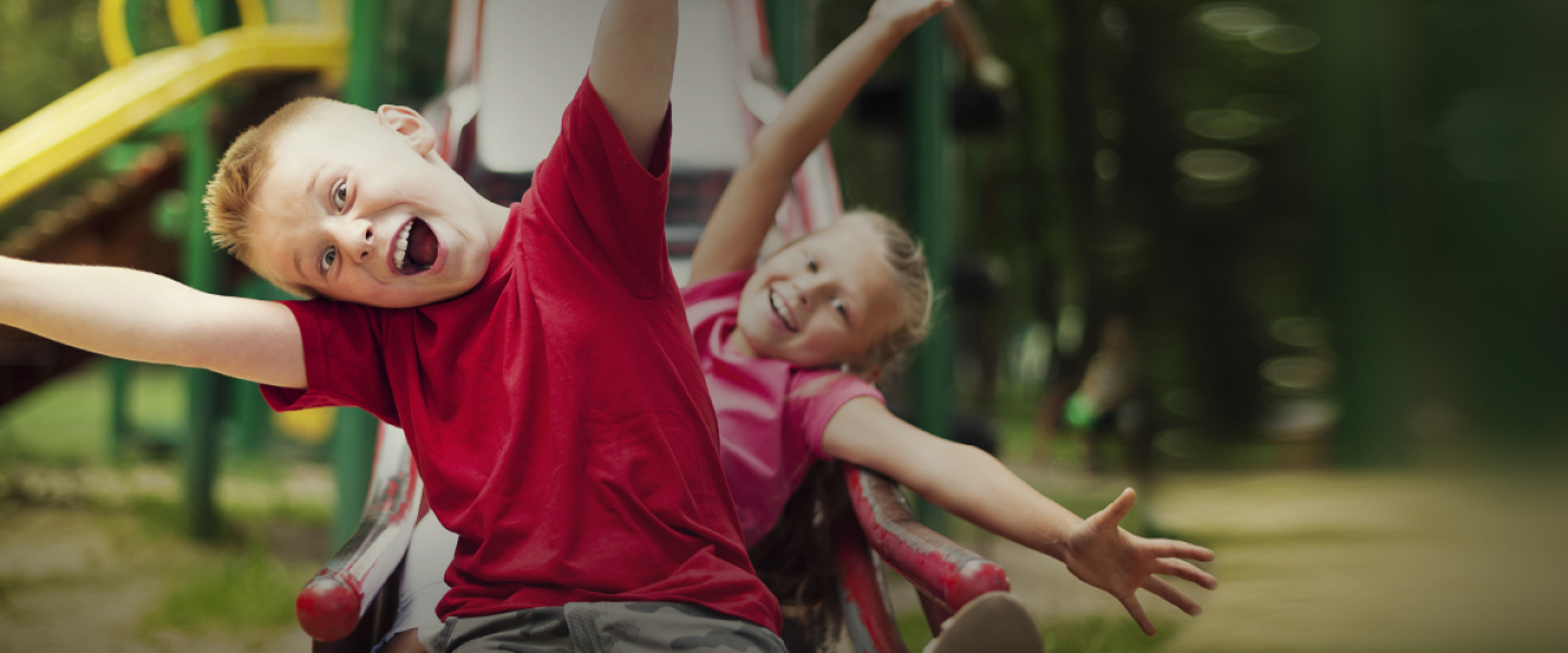 Kids sliding down slide