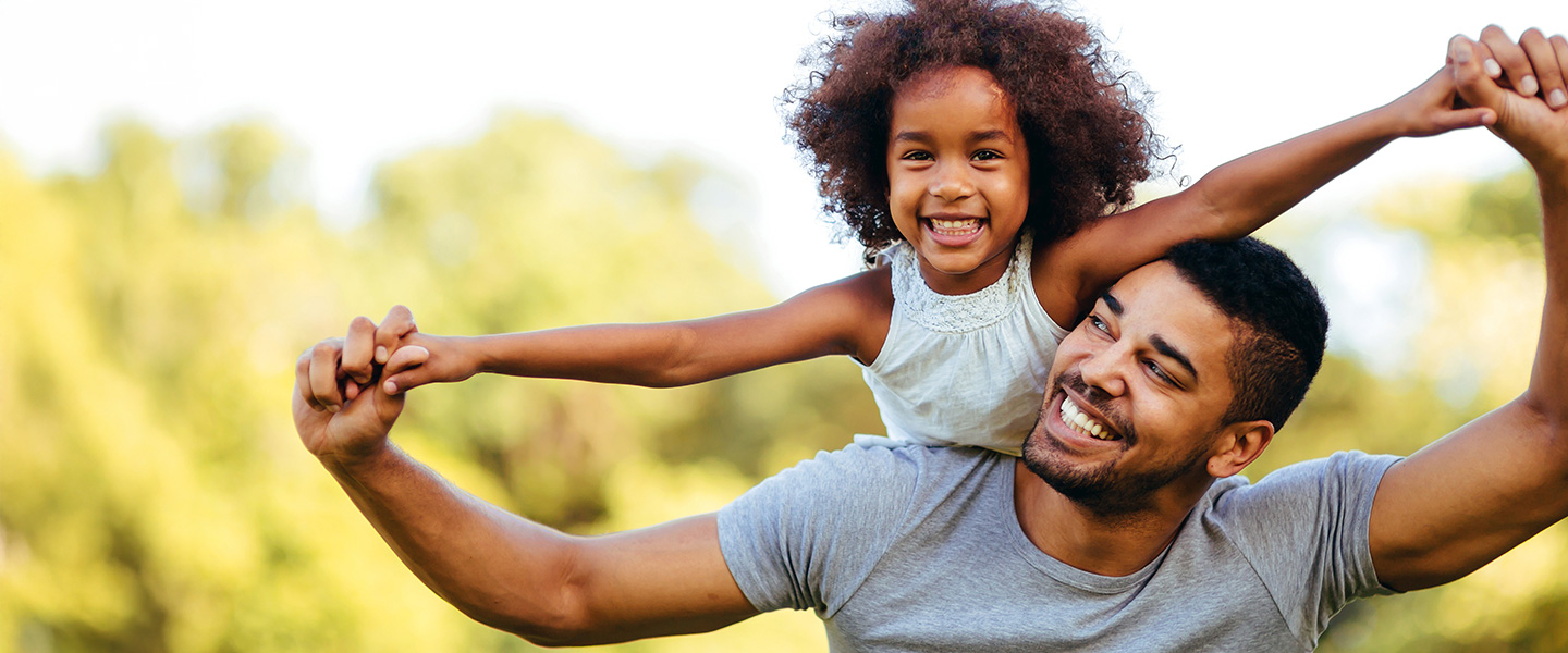 Father and daughter holding hands and smiling