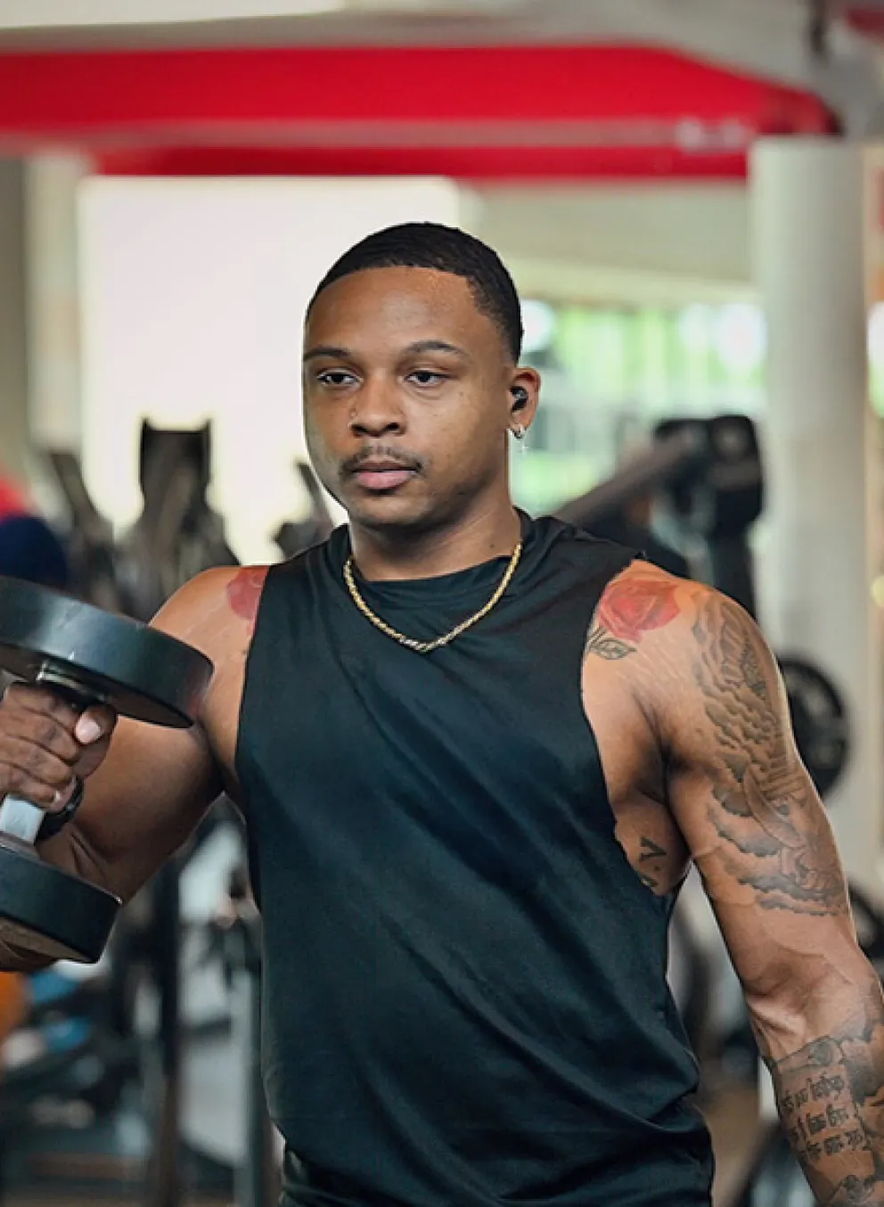 Black man lifting weights at a YMCA