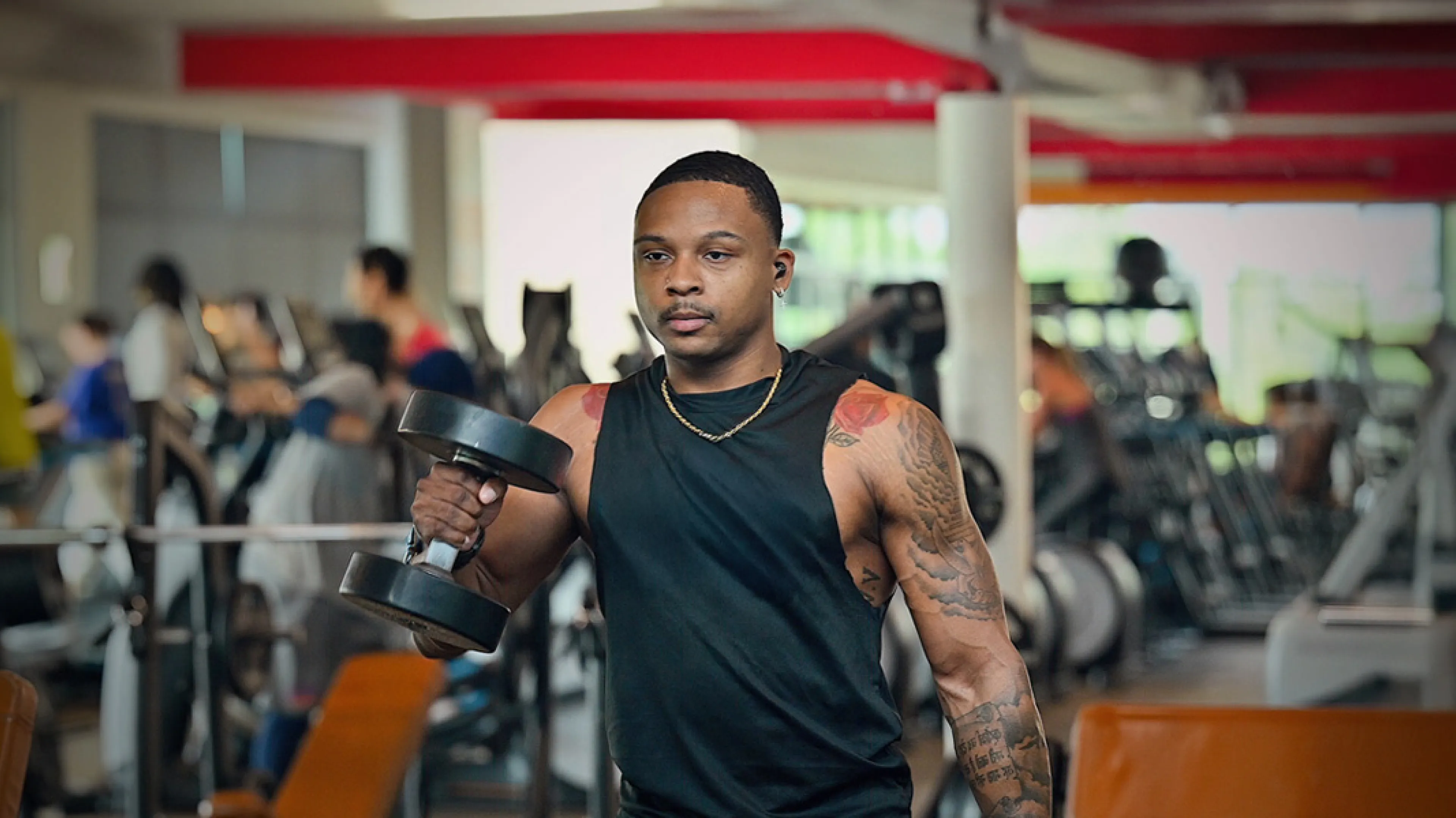 Black man lifting weights at a YMCA